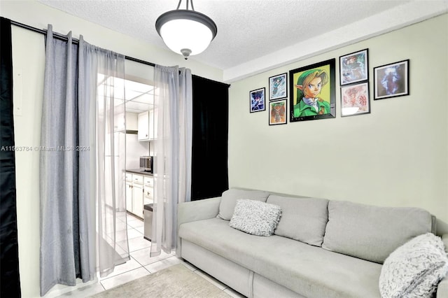 living room with light tile patterned floors and a textured ceiling