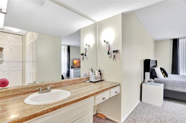 bathroom with vanity and a textured ceiling