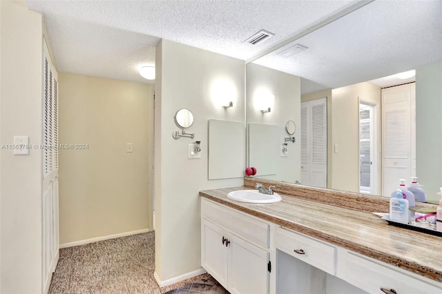 bathroom with vanity and a textured ceiling