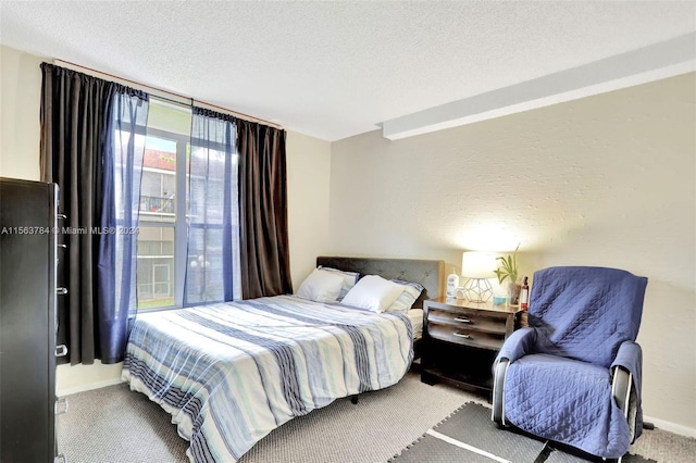 bedroom with a textured ceiling and carpet flooring