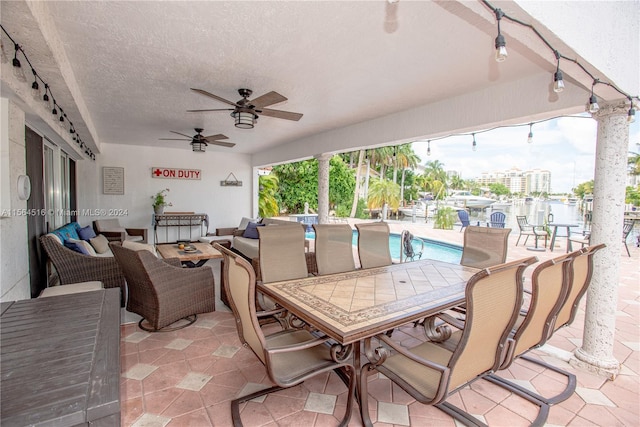 view of terrace with an outdoor living space and ceiling fan