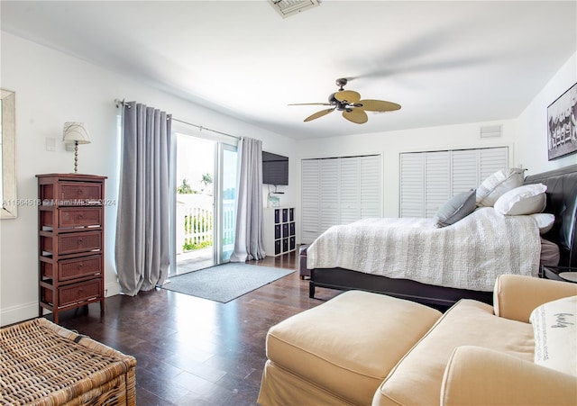 bedroom featuring dark hardwood / wood-style floors, two closets, ceiling fan, and access to outside