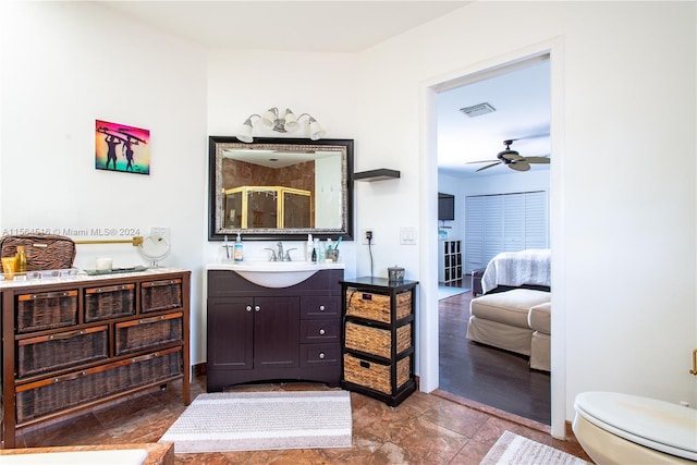 bathroom featuring ceiling fan, vanity, toilet, and hardwood / wood-style flooring