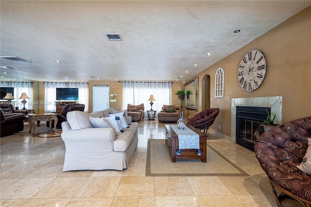 tiled living room with a textured ceiling