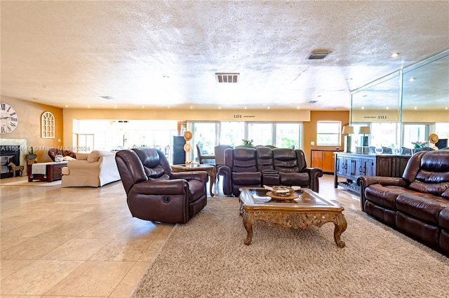 living room featuring light tile floors and a textured ceiling