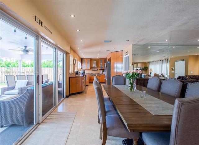 tiled dining area with ceiling fan, french doors, and a textured ceiling