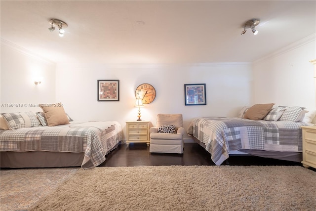 bedroom featuring crown molding and dark hardwood / wood-style flooring