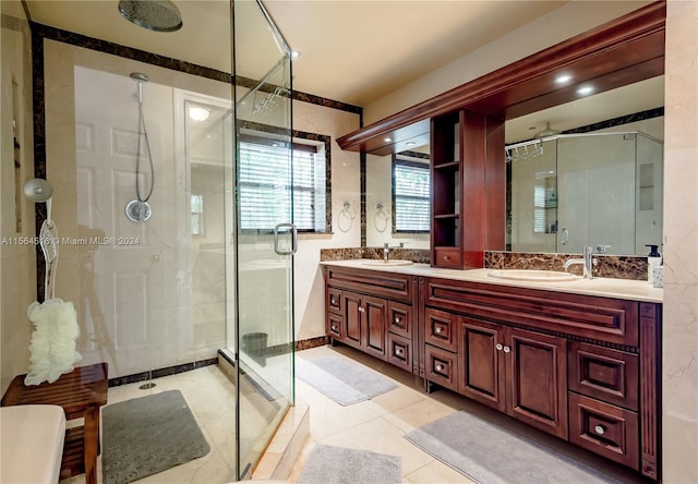 bathroom featuring an enclosed shower, double sink, tile floors, and large vanity