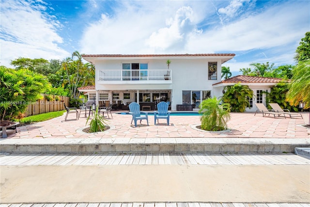 back of property featuring a patio area and a balcony