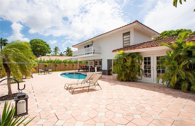 view of swimming pool with french doors and a patio