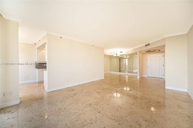 tiled empty room featuring a notable chandelier and ornamental molding