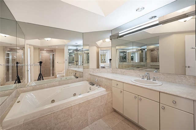 bathroom with tiled bath, oversized vanity, and tile floors