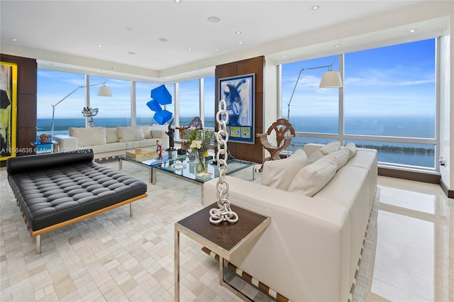 tiled living room featuring a water view