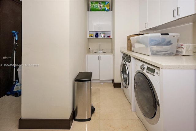 washroom featuring separate washer and dryer, cabinets, light tile flooring, and sink