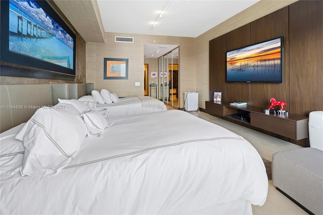 carpeted bedroom with wood walls