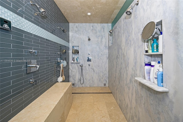 bathroom with tile flooring and tiled shower