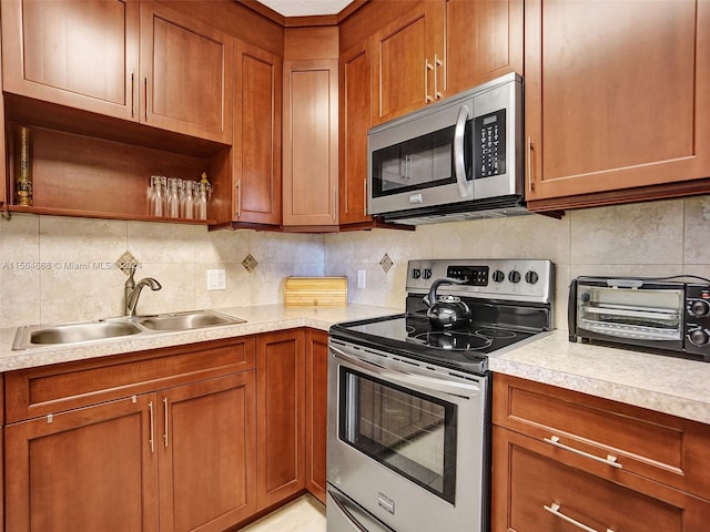 kitchen featuring appliances with stainless steel finishes, sink, and backsplash