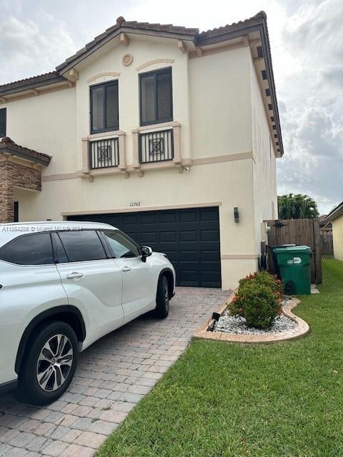 mediterranean / spanish house with a front yard and a garage