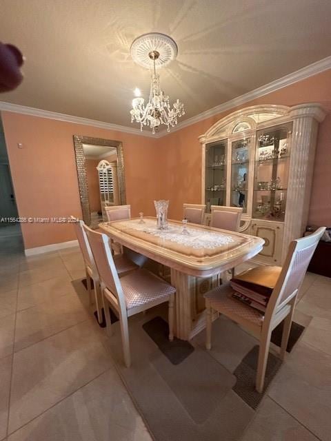 tiled dining room featuring ornamental molding and a chandelier