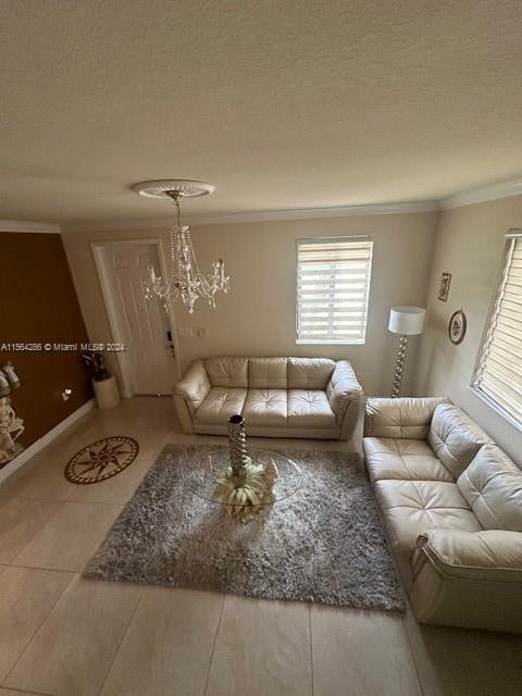 tiled living room with an inviting chandelier, a textured ceiling, and crown molding