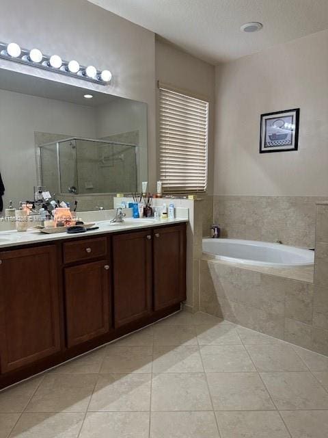 bathroom featuring shower with separate bathtub, dual vanity, and tile floors