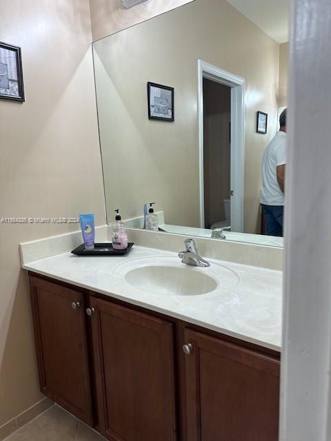 bathroom featuring tile floors and vanity with extensive cabinet space