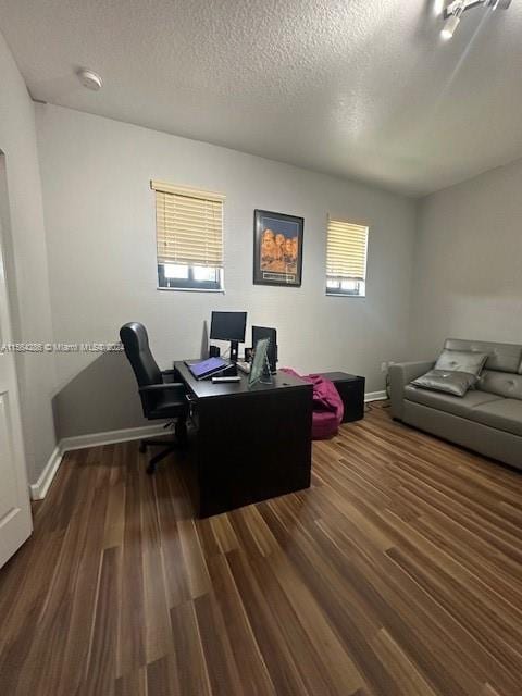 office area featuring dark hardwood / wood-style floors and a textured ceiling