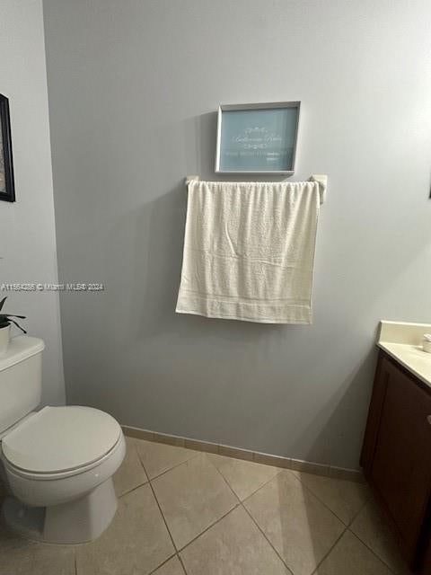 bathroom featuring vanity, tile floors, and toilet