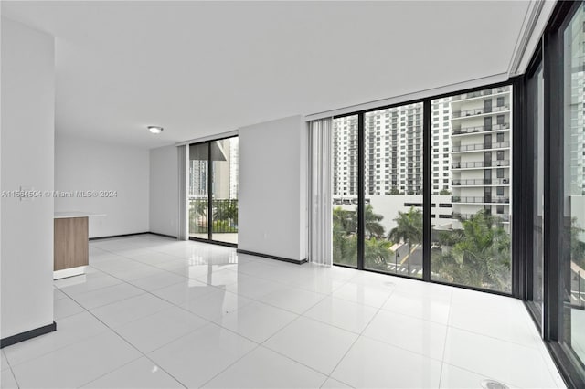 tiled empty room with floor to ceiling windows