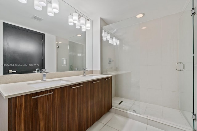 bathroom featuring tile patterned floors, vanity, and an enclosed shower