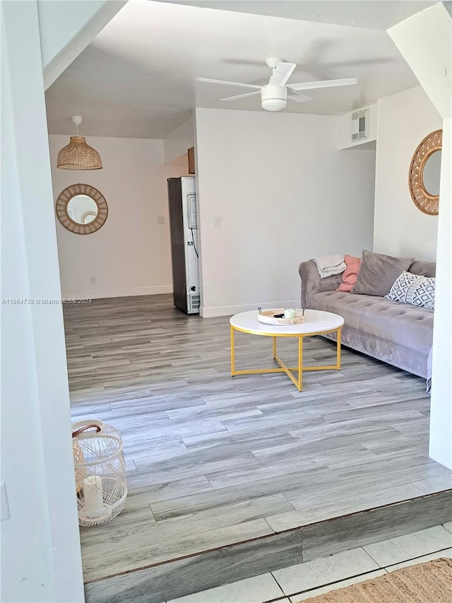 unfurnished living room with ceiling fan and light hardwood / wood-style flooring