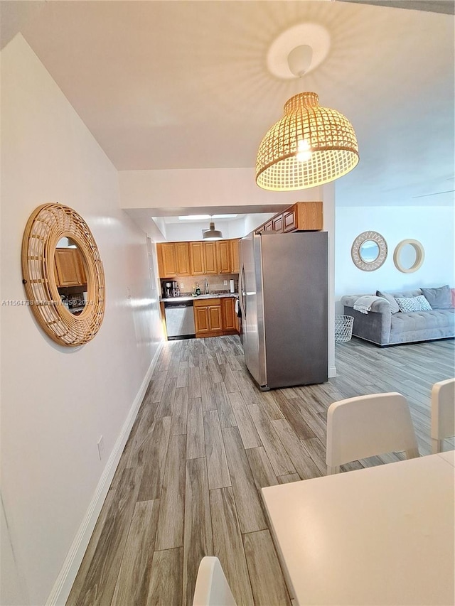 hallway with light hardwood / wood-style flooring