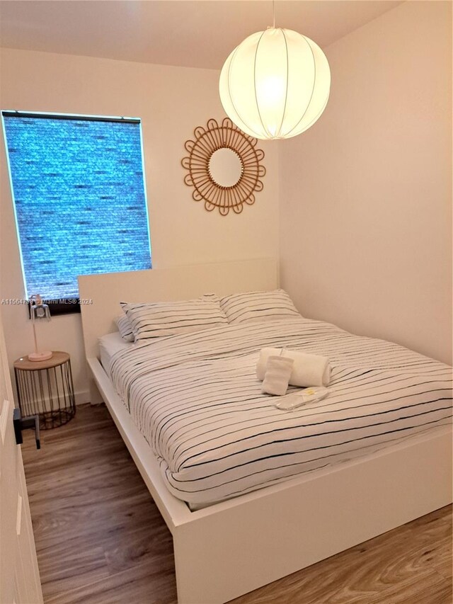 bedroom featuring dark hardwood / wood-style flooring