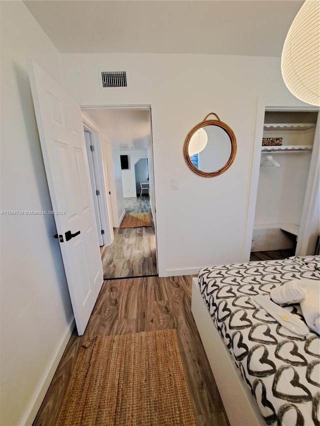 bedroom with a closet and dark wood-type flooring