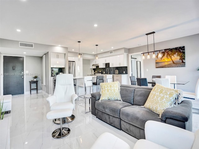 tiled living room featuring sink