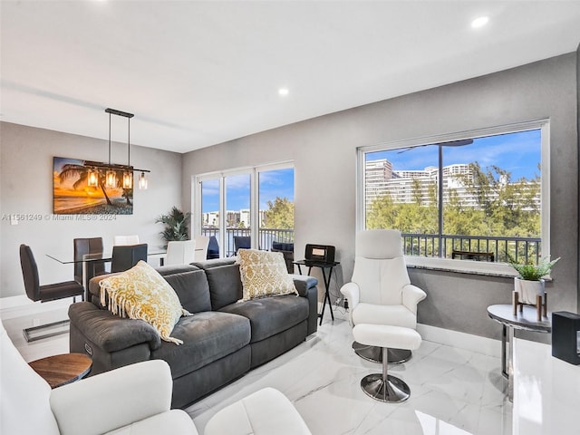 living room with light tile floors and a notable chandelier