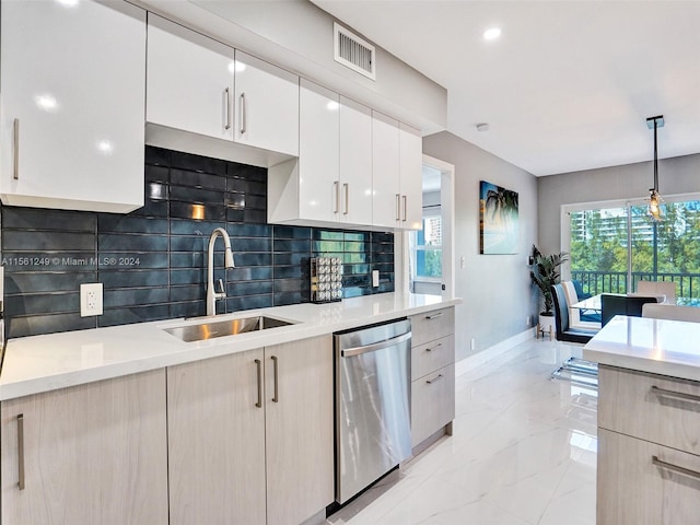 kitchen featuring hanging light fixtures, backsplash, dishwasher, sink, and white cabinets