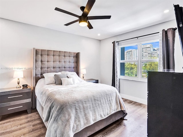 bedroom with ceiling fan and wood-type flooring