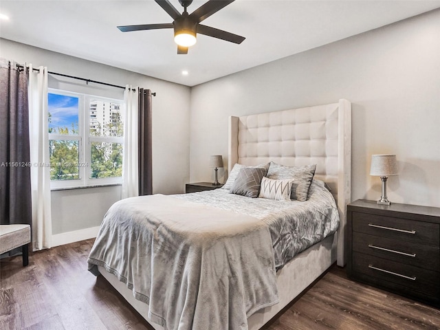 bedroom with ceiling fan and dark wood-type flooring