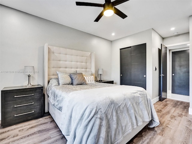 bedroom with ceiling fan and light hardwood / wood-style flooring