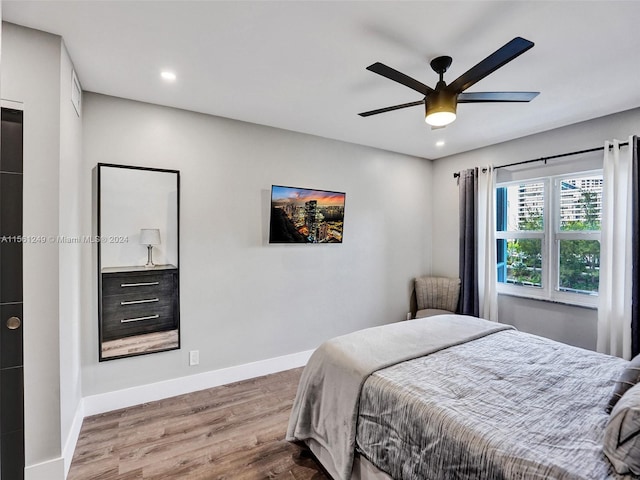 bedroom with ceiling fan and dark wood-type flooring