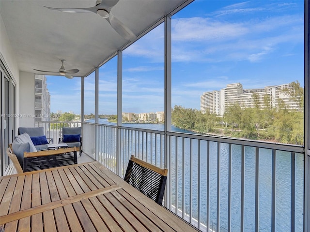 unfurnished sunroom featuring ceiling fan