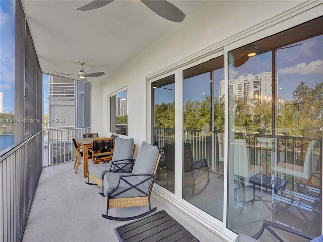 sunroom featuring ceiling fan