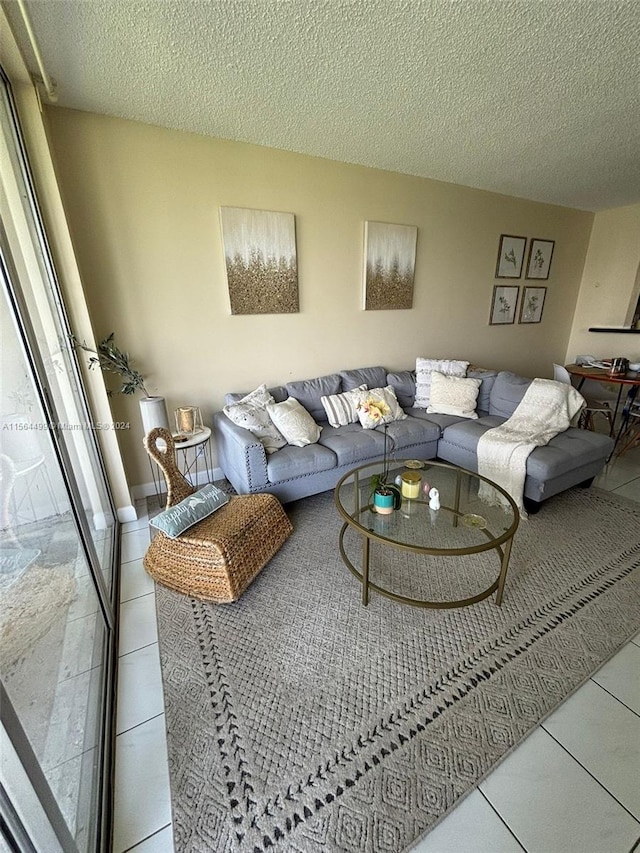 living room featuring a textured ceiling and light tile patterned floors