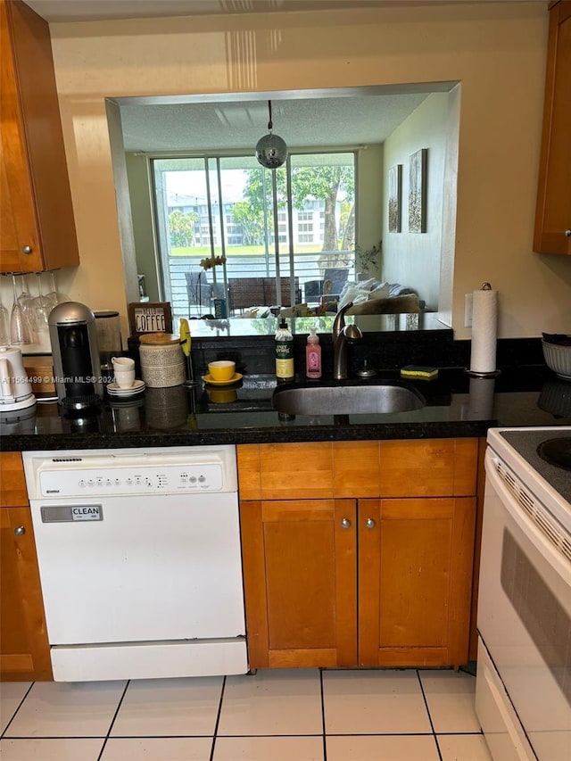 kitchen with sink, white appliances, and light tile patterned flooring