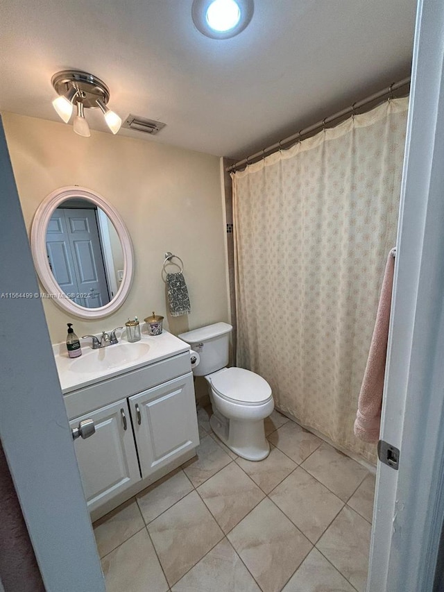 bathroom featuring vanity, toilet, and a shower with shower curtain