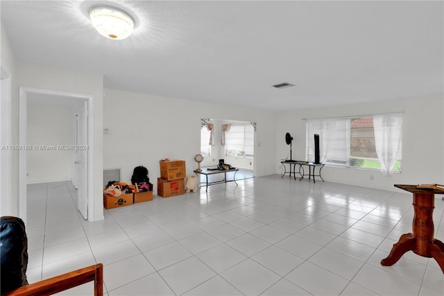 tiled living room featuring a healthy amount of sunlight