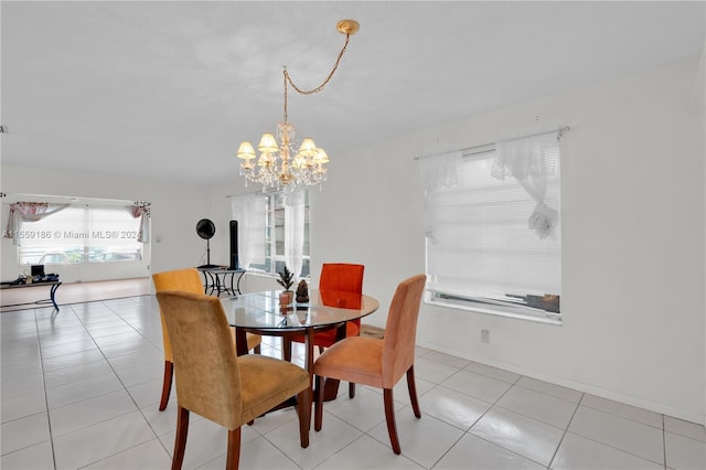 dining area with a chandelier and light tile patterned floors