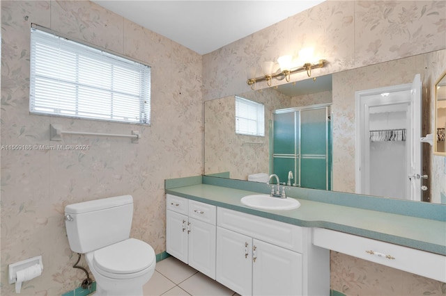 bathroom with toilet, tile patterned floors, a wealth of natural light, and a shower with shower door