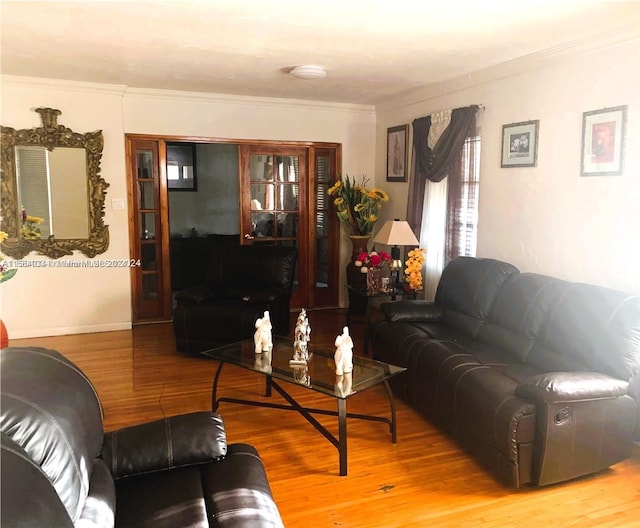 living room featuring hardwood / wood-style floors and ornamental molding